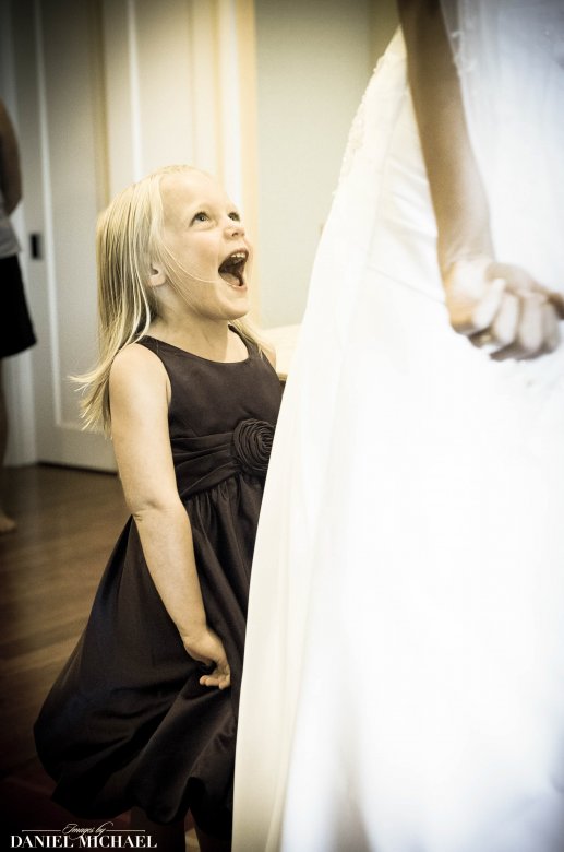 Candid Photo of Excited flower girl in moment with bride at Cincinnati wedding
